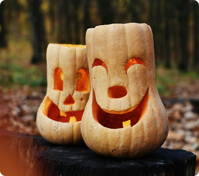 Two carved pumpkins with smiling faces.