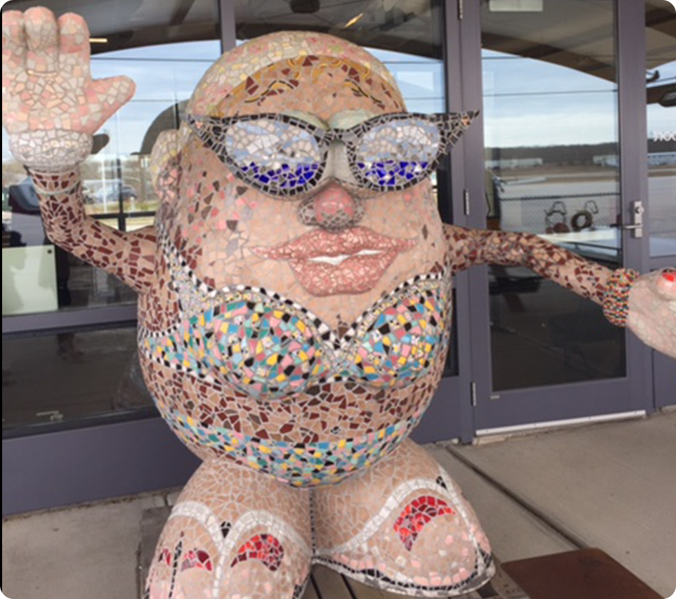 Mosaic sculpture of figure with sunglasses.